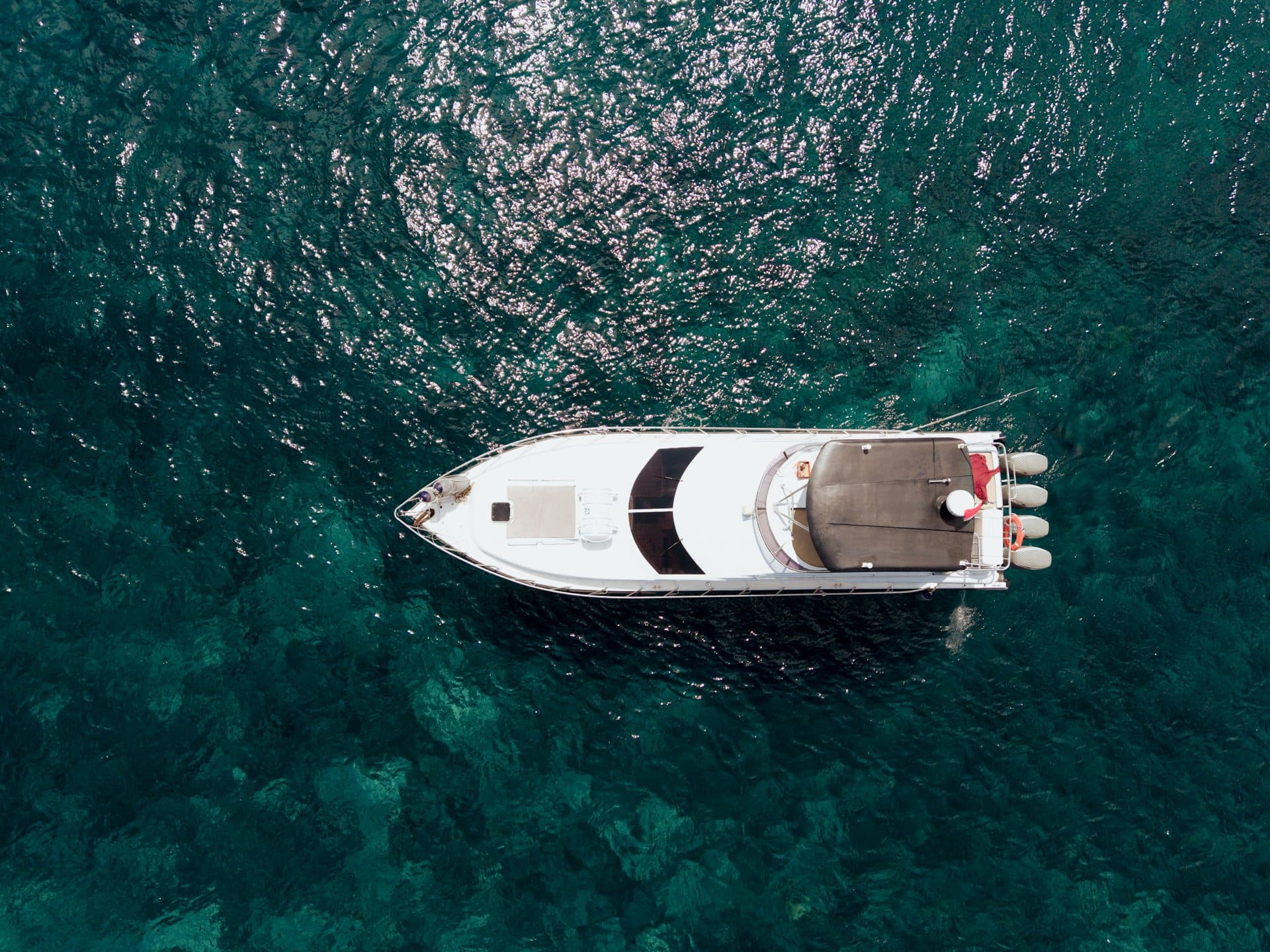 Top-down aerial of the Azure Dream yacht on turquoise water in Bali
