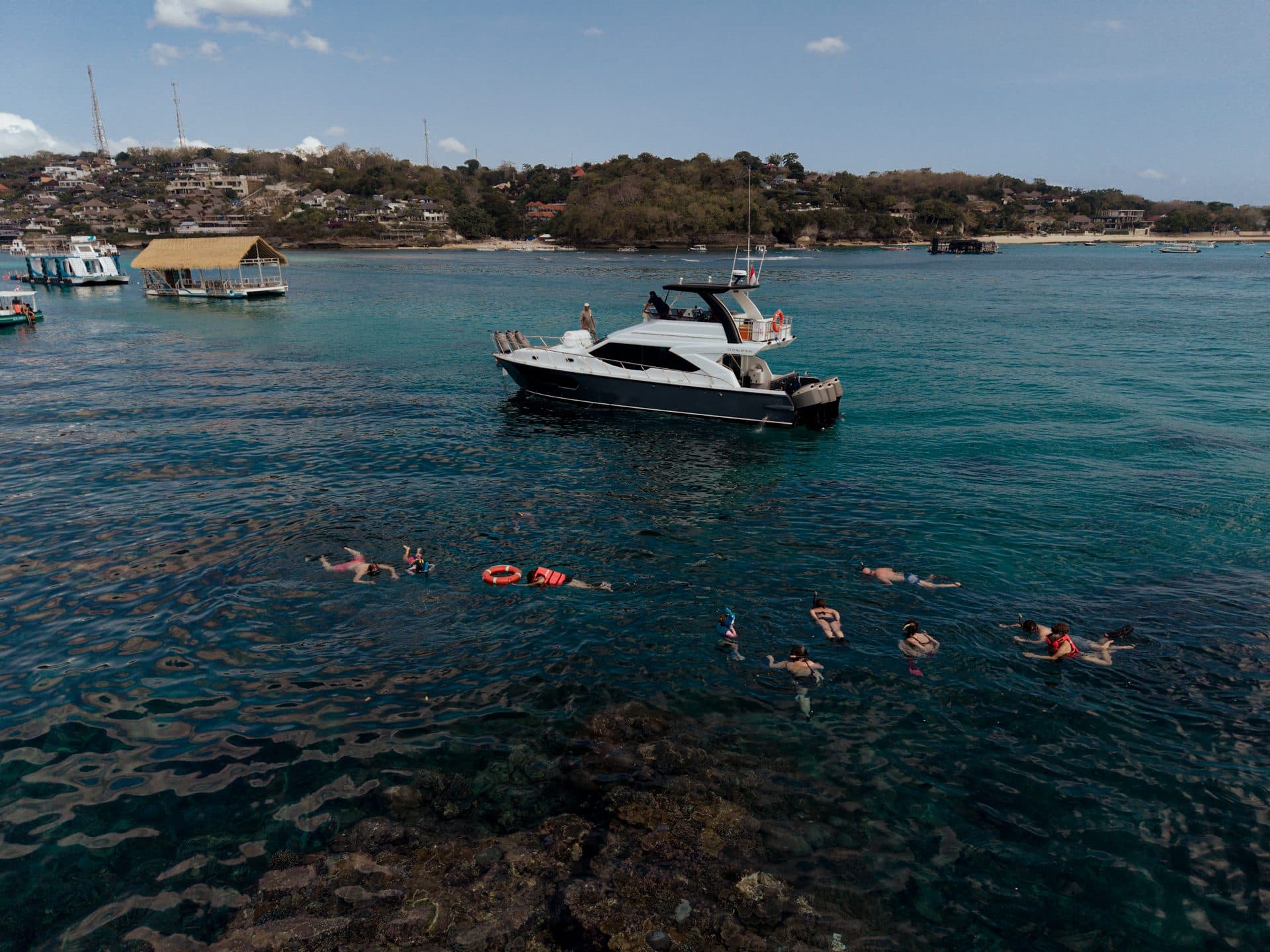 Azure Dream yacht with guests snorkeling nearby at a Bali island