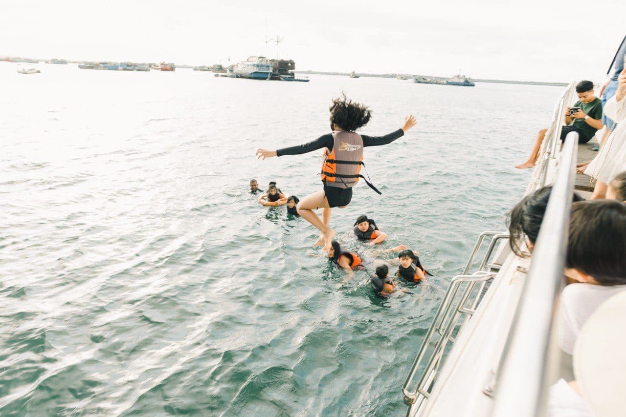 Guests jumping into the sea during a birthday charter