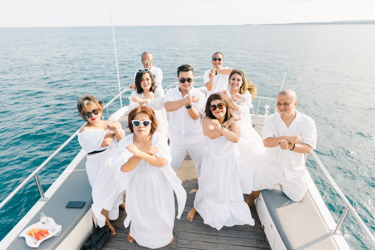 Large group celebration in white aboard the yacht in Bali