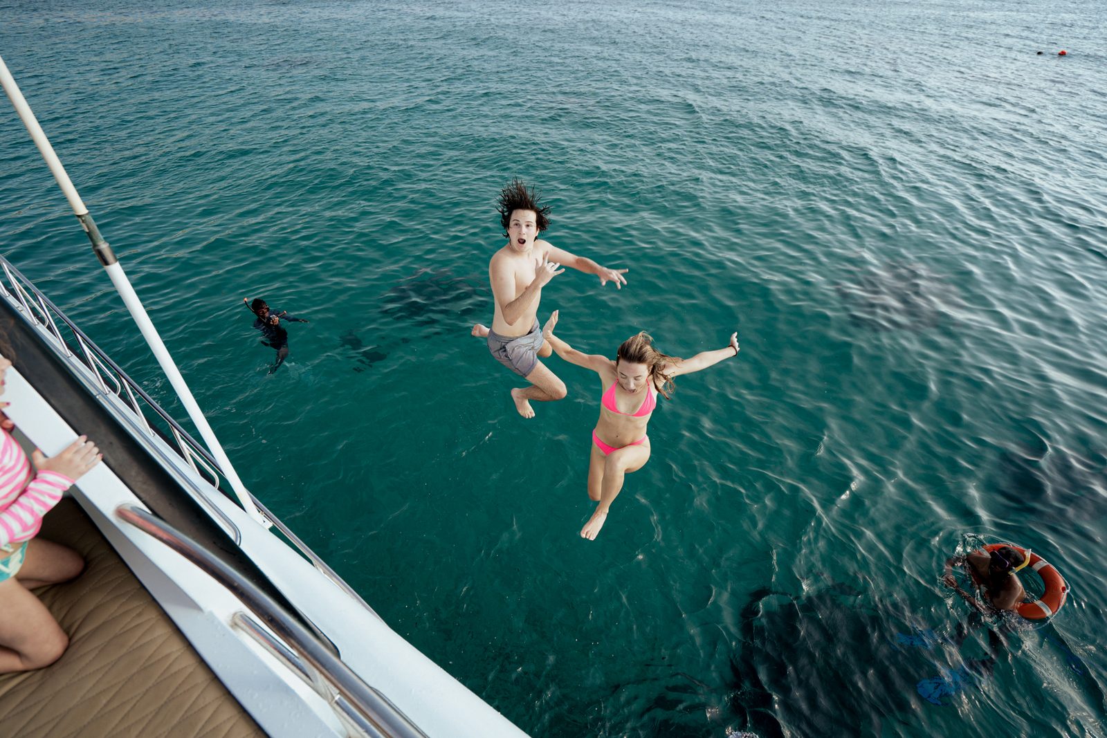Guests jumping off the yacht into the sea in Bali